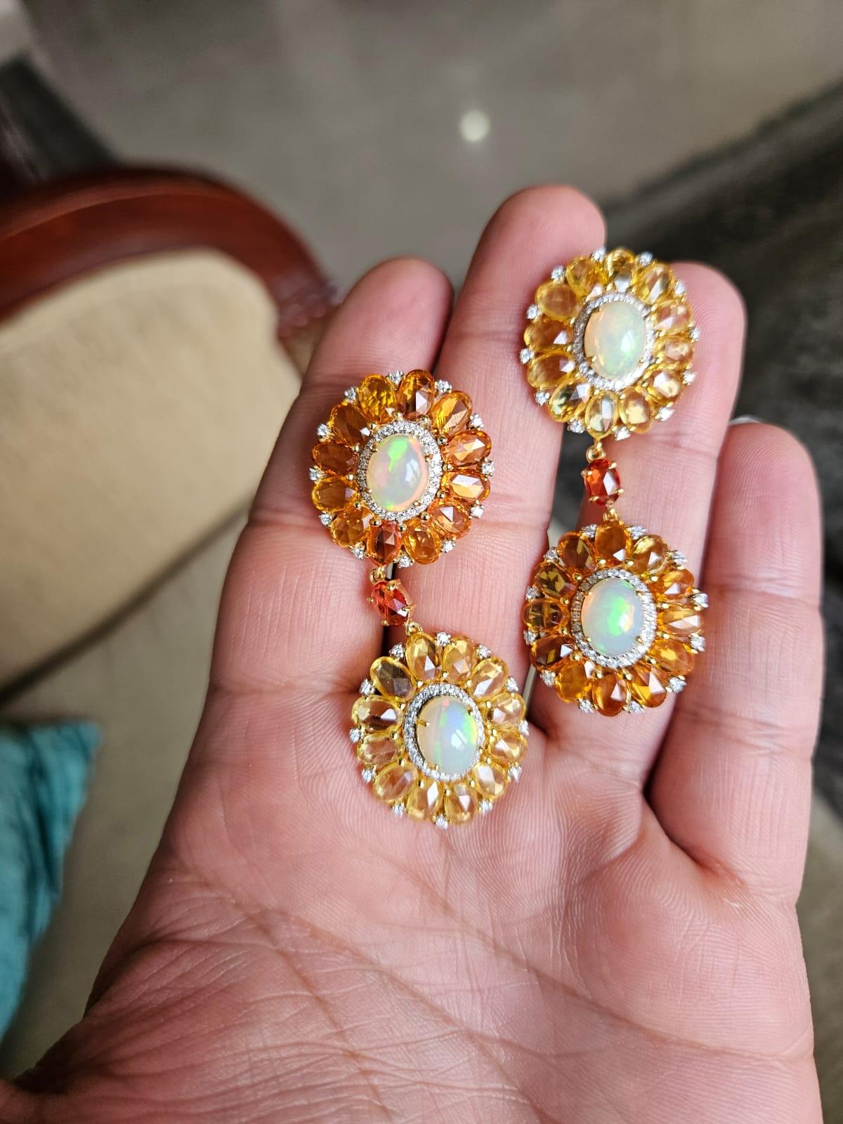 A very gorgeous and beautiful, modern style, Opal & Multi Sapphires Chandelier/ Dangle Earrings set in 18K Yellow Gold & Diamonds. The weight of the Opal is 6.29 carats. The Opals are of Ethiopian origin. The weight of Yellow / Orange Multi