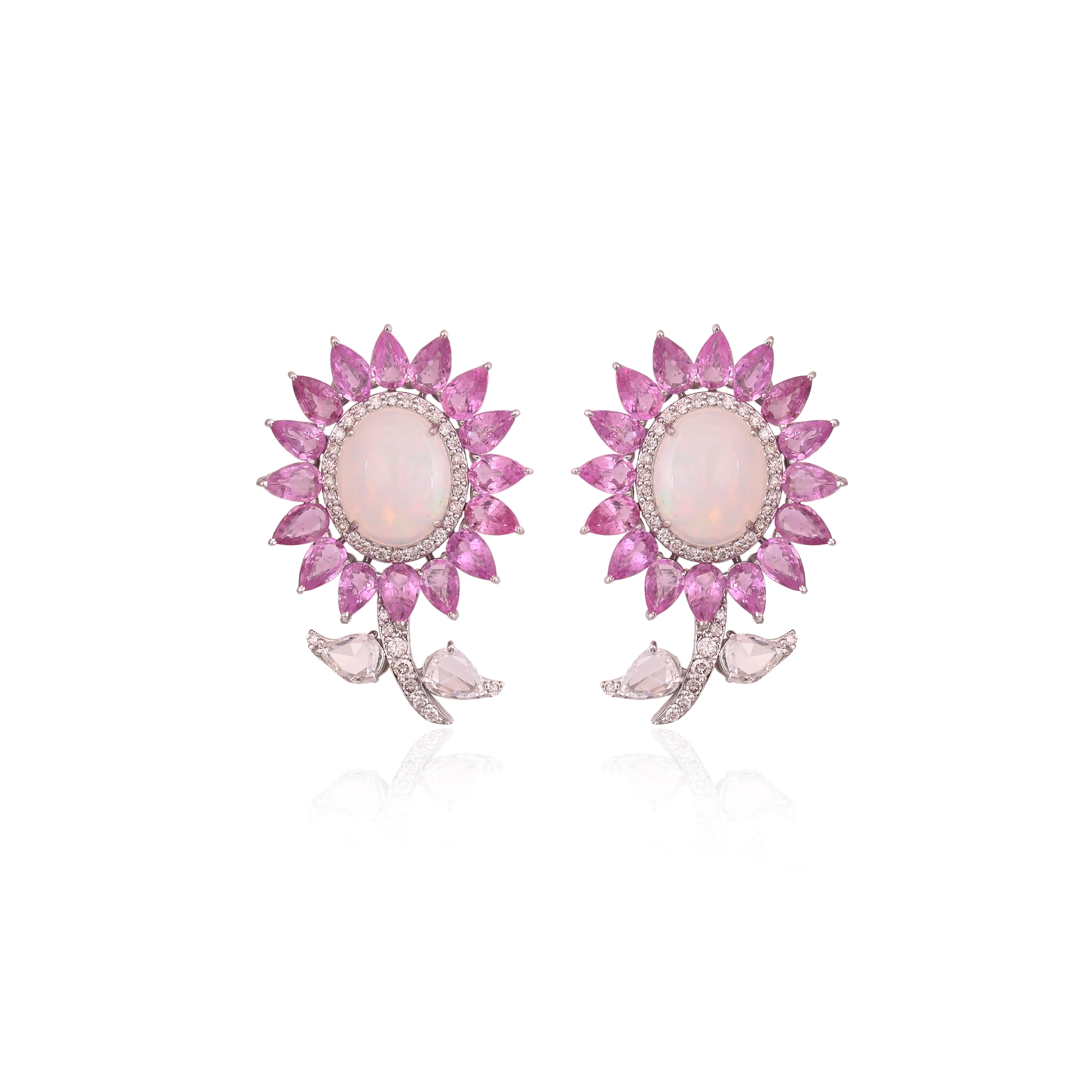 A very gorgeous and modern, Opal & Pink Sapphires Stud Earrings set in 18K White Gold & Diamonds. The weight of the Opals is 7.16 carats. The Opals are of Ethiopian origin. The Pink Sapphires weigh 7.94 carats. The Pink Sapphires are of Madagascar