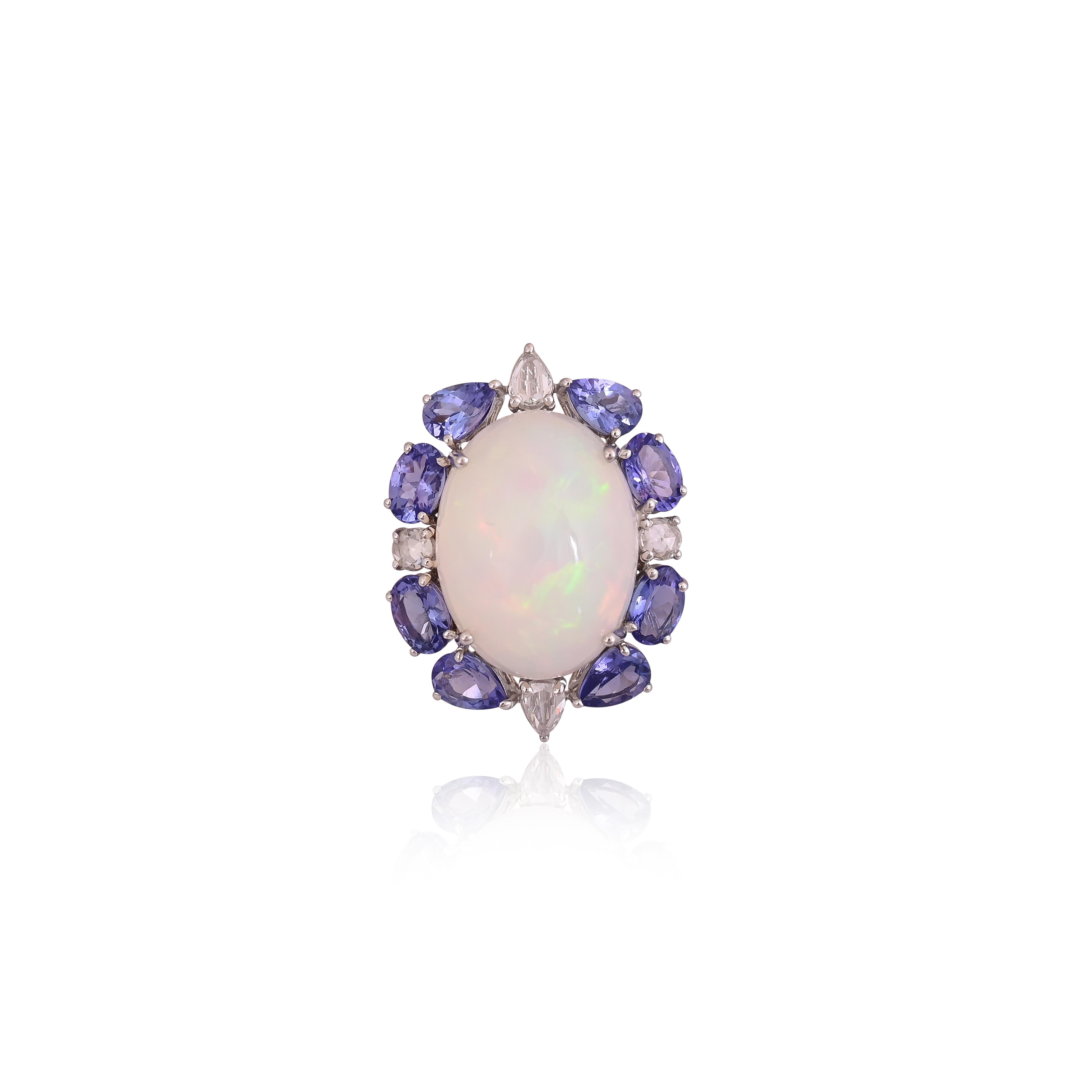 A very beautiful & gorgeous, modern style, Opal & Tanzanite Ring set in 18K White Gold & Diamonds. The Opal Cabochon is of Ethiopian origin and weighs 13.68 carats. The Tanzanite weight is 4.19 carats. The Tanzanites are responsibly sourced from