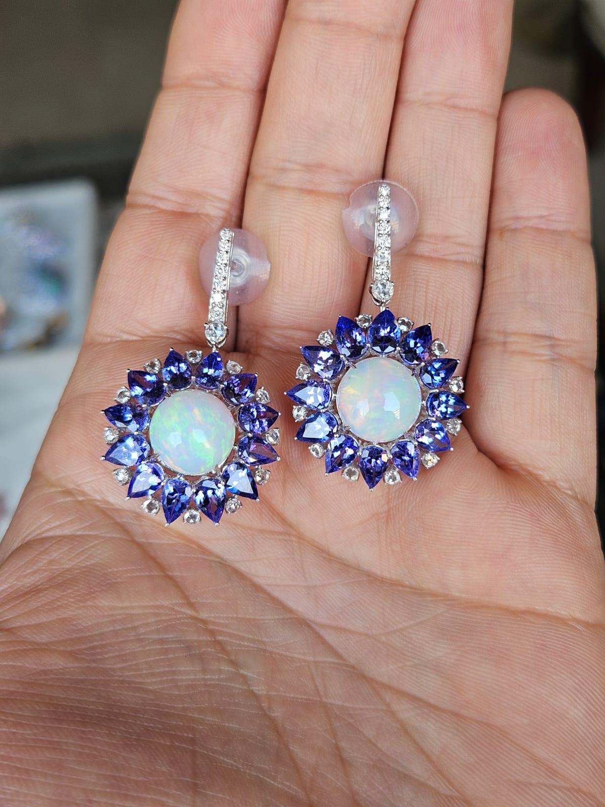 A very gorgeous and beautiful, modern style, Ethiopian Opal & Tanzanite Dangle Earrings set in 18K White Gold & natural Diamonds. The weight of the cabochon Opals is 6.26 carats. The Opals are of Ethiopian origin and have a green-orange play of