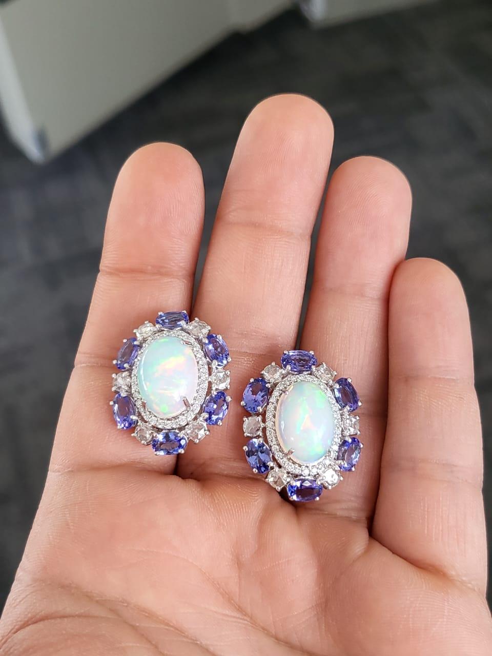 A very gorgeous and one of a kind, Opal & Tanzanite Stud / Lever - Back Earrings set in 18K White Gold & Diamonds. The weight of the Ethiopian Opals are 7.70 carats. The weight of the Tanzanites is 5.90 carats. The Tanzanites are completely natural,