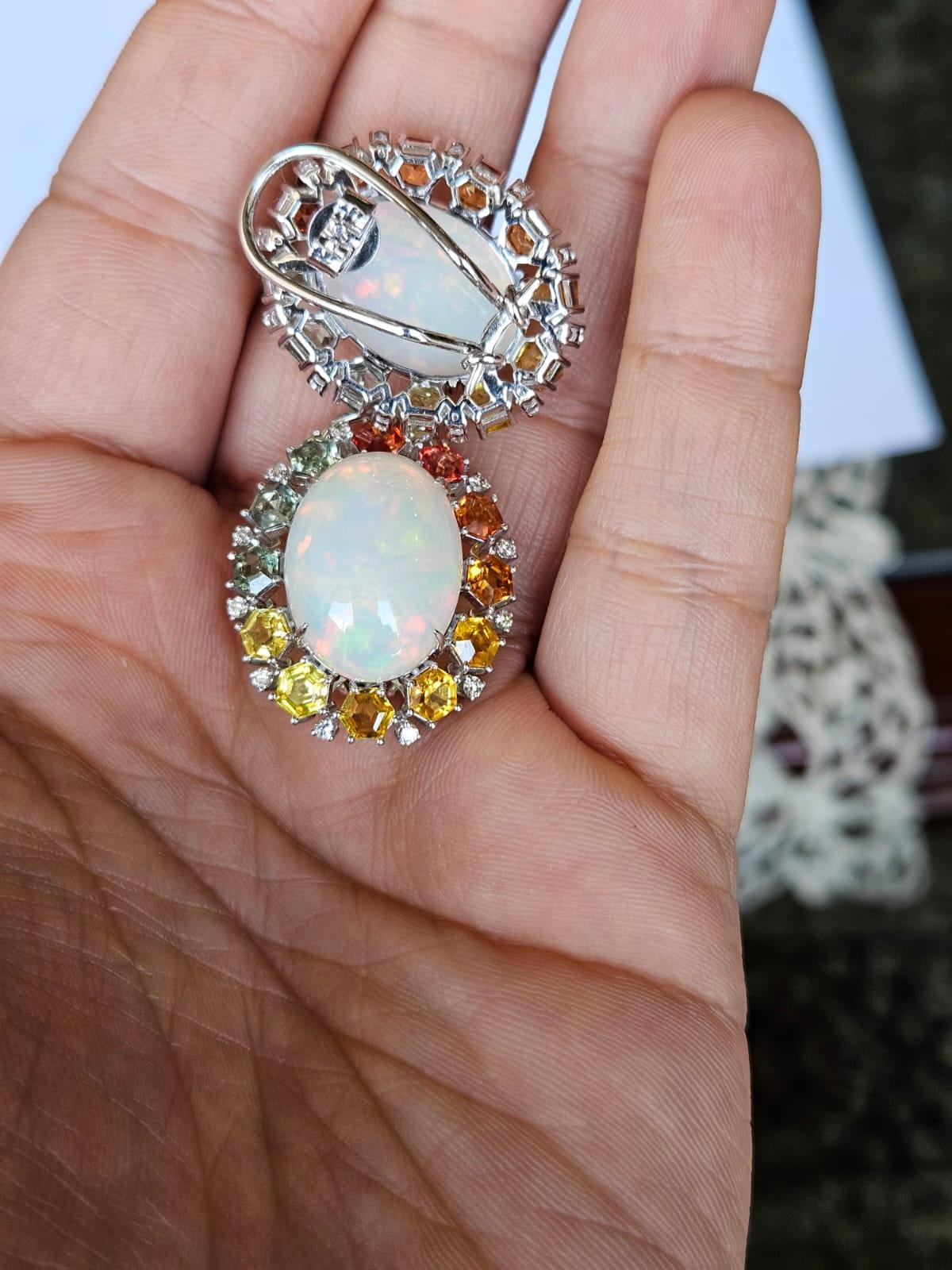 A very gorgeous and beautiful, modern style, Opal & Multi Sapphires Stud Earrings set in 18K Gold & natural Diamonds. The weight of the Opal is 7.96 carats. The Opals are of Ethiopian origin and have a Red - Green play of colour. The weight of the
