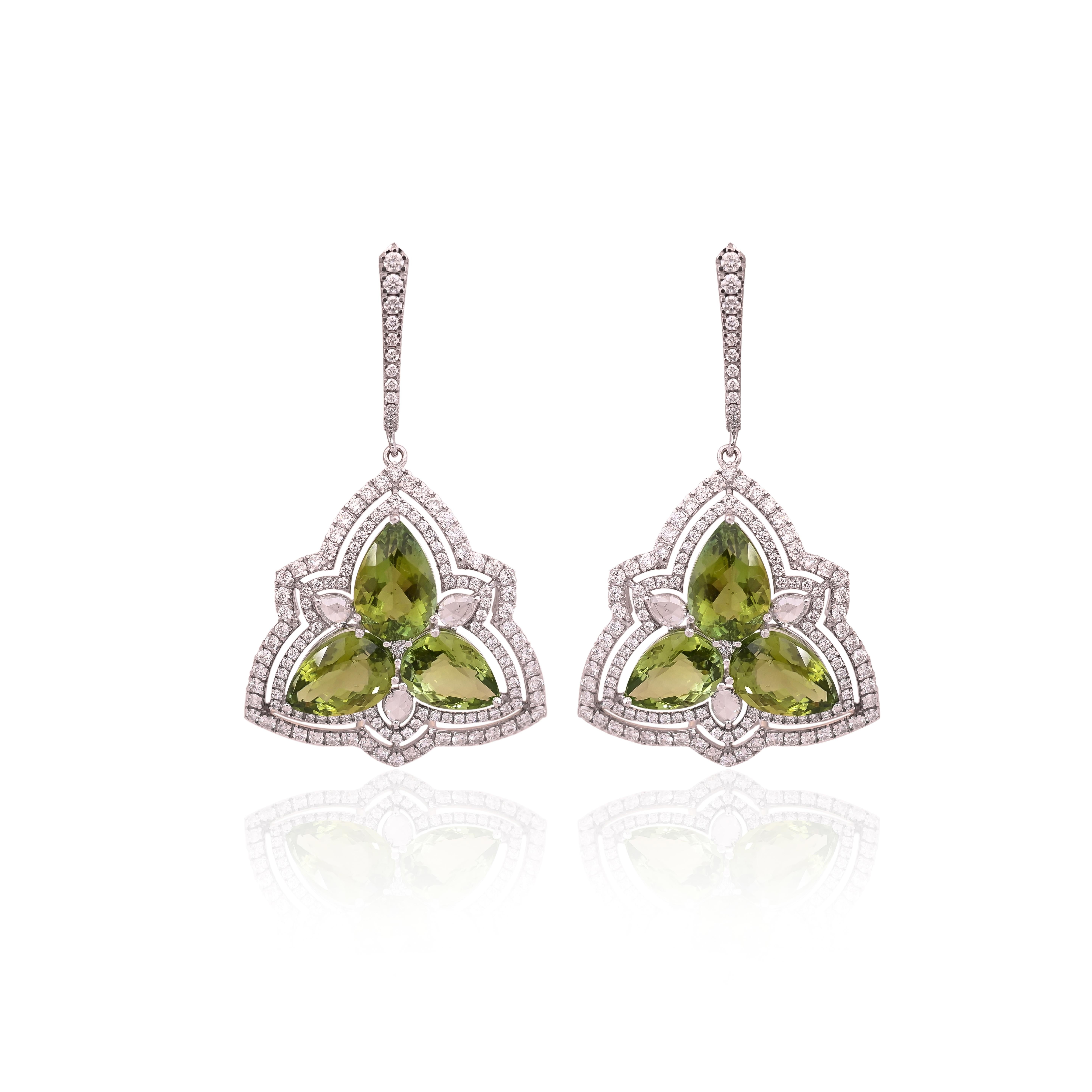 A very gorgeous and modern style, Green tourmaline Dangle Earrings set in 18K White Gold & Diamonds. The weight of the Green Tourmalines is 17.38 carats. The combined Diamonds weight is 3.39 carats. Net 18K White Gold weight is 8.19 grams. The gross