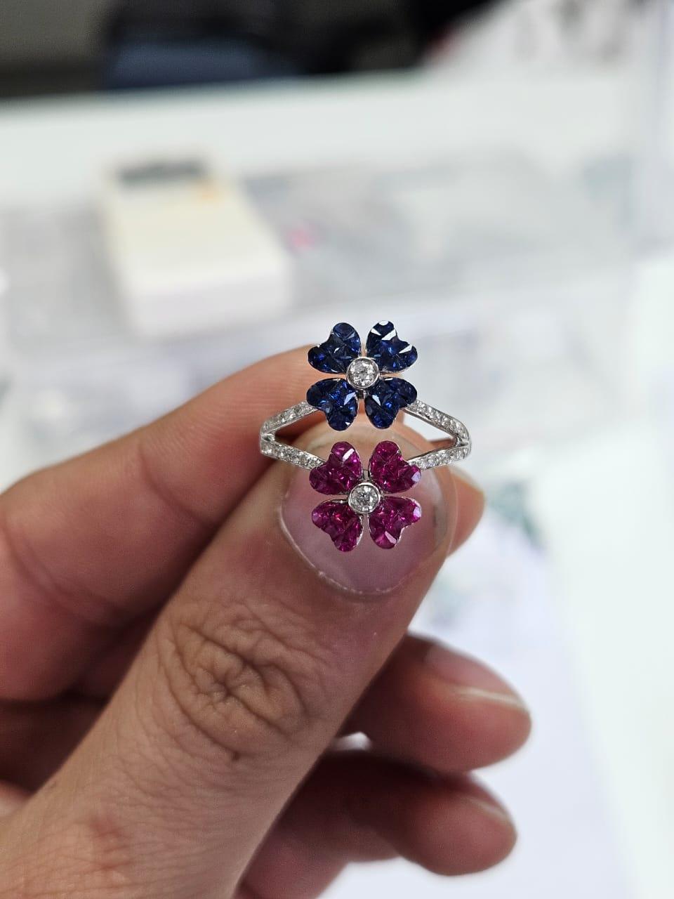 A very gorgeous and beautiful, modern style, Blue Sapphires & Rubies Custer Ring set in 18K White Gold & natural Diamonds.. The weight of the Rubies is 0.80 carats. The weight of the Blue Sapphires is 0.70 carats. The Rubies & Blue Sapphires are of