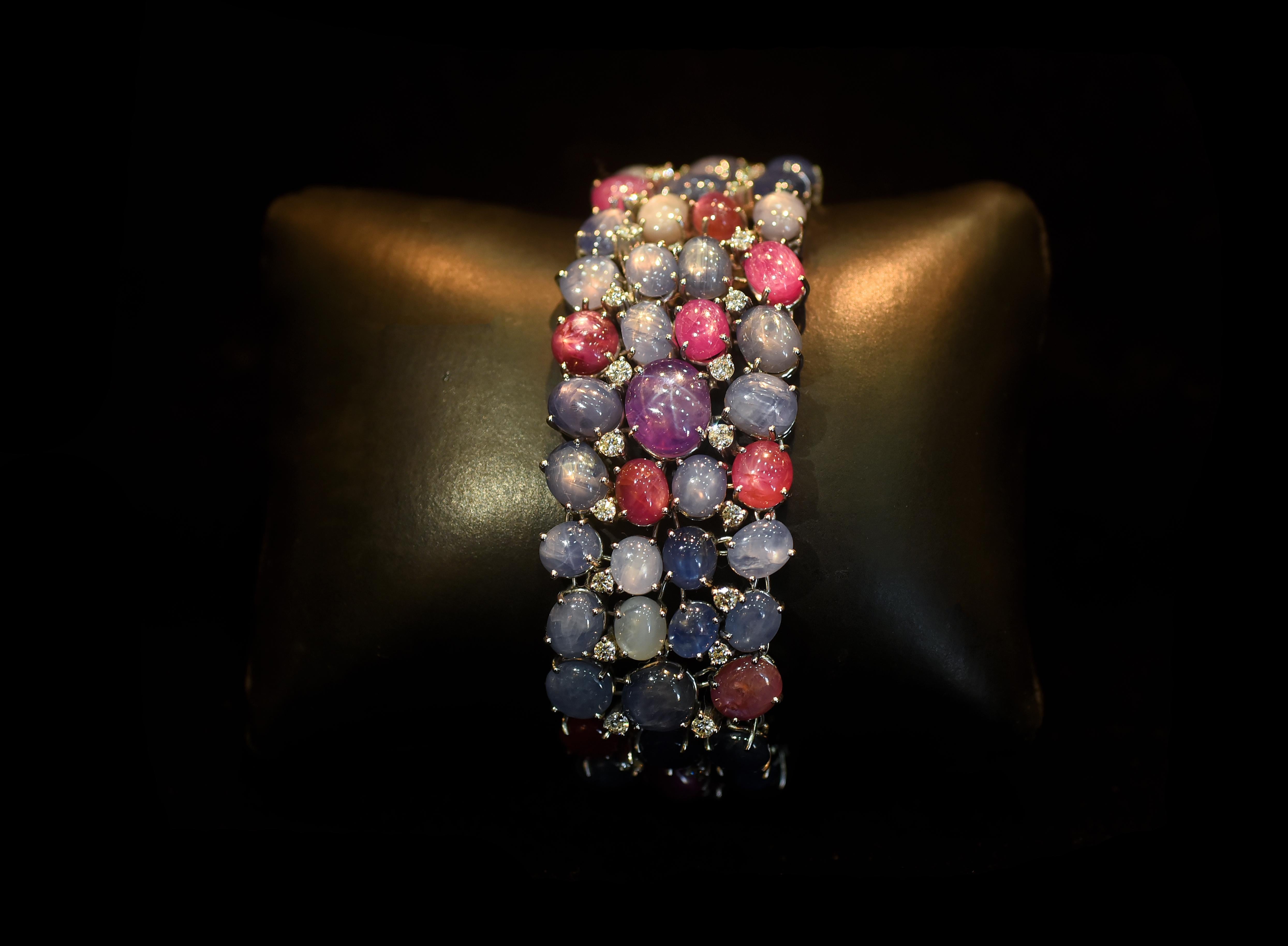 A gorgeous and one of a kind Ceylon Star Sapphire Bracelet set in 18K Gold & Diamonds. Star Sapphire is a rare rarity of Sapphire that exhibits a rare asterism (a six-rayed star) floating across the stone under specific lighting. The Star Sapphire