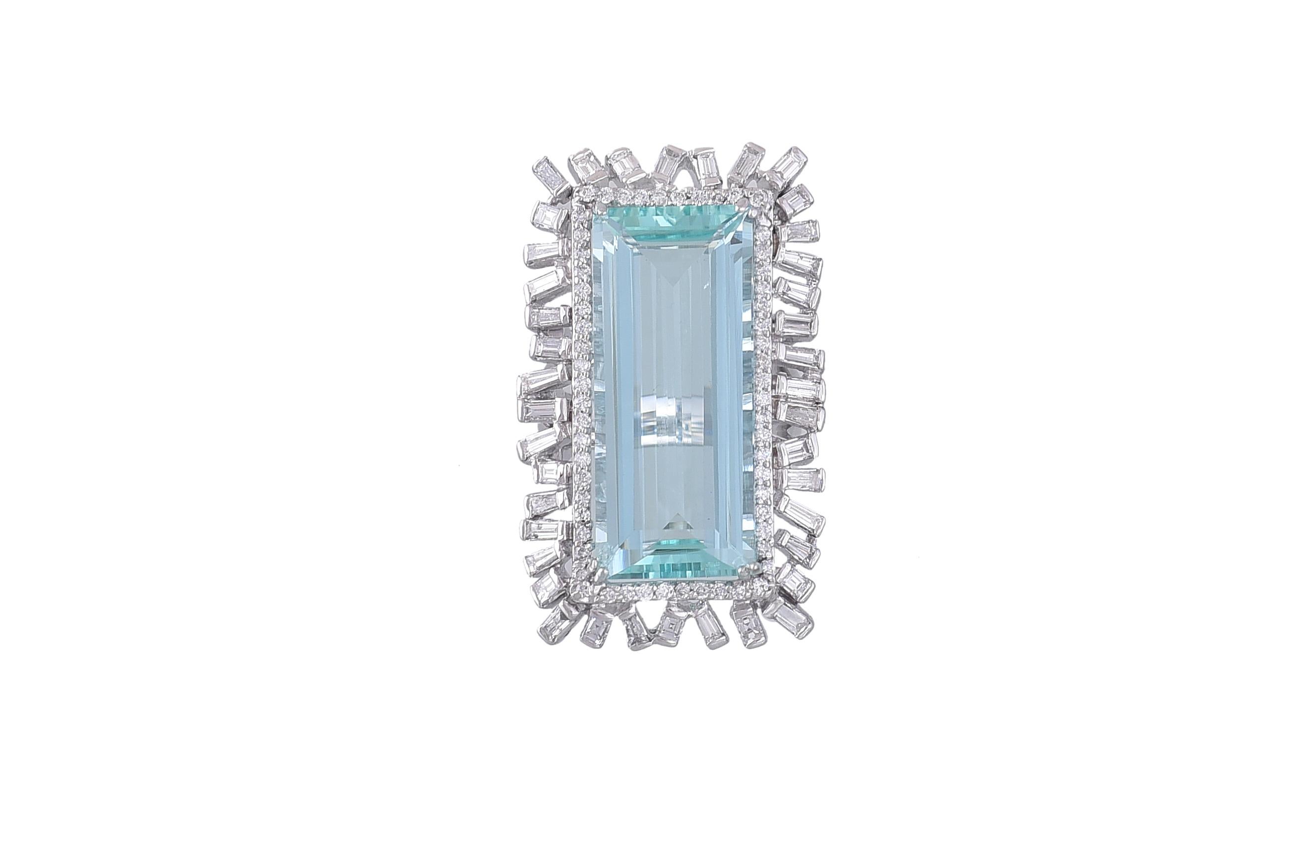 A very gorgeous and chic Aquamarine and Baguette Diamonds cocktail Ring set in 18K gold. The Aquamarine is natural and of African origin. The weight of the Aquamarine is 15.93 carats. The weight of the Baguette Diamonds is 1.80 carats. The ring is