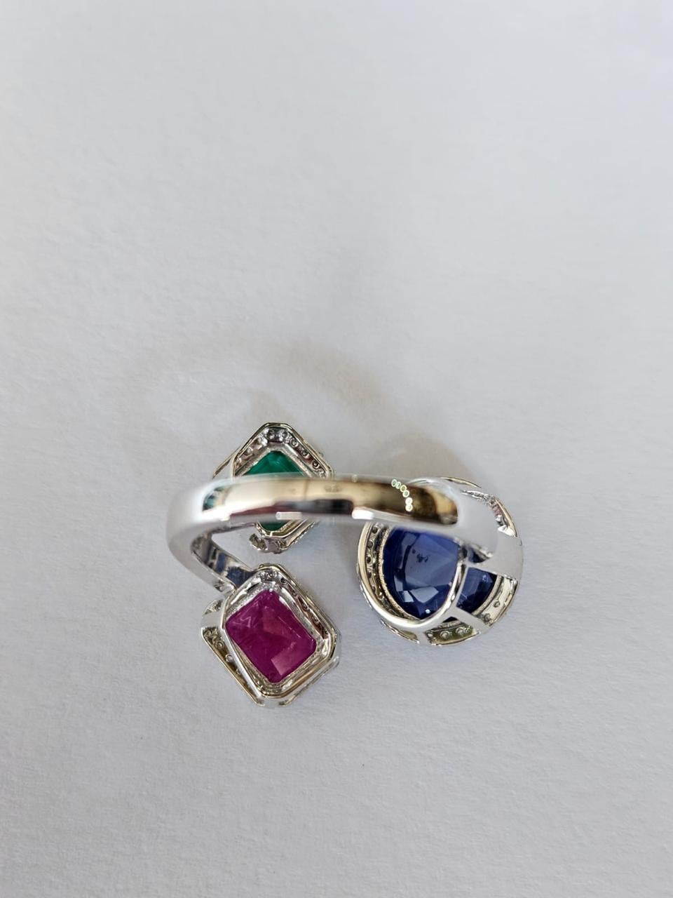 Modern Set in 18K Gold, natural Blue Sapphire, Emerald, Ruby & Diamond Three-Stone Ring For Sale