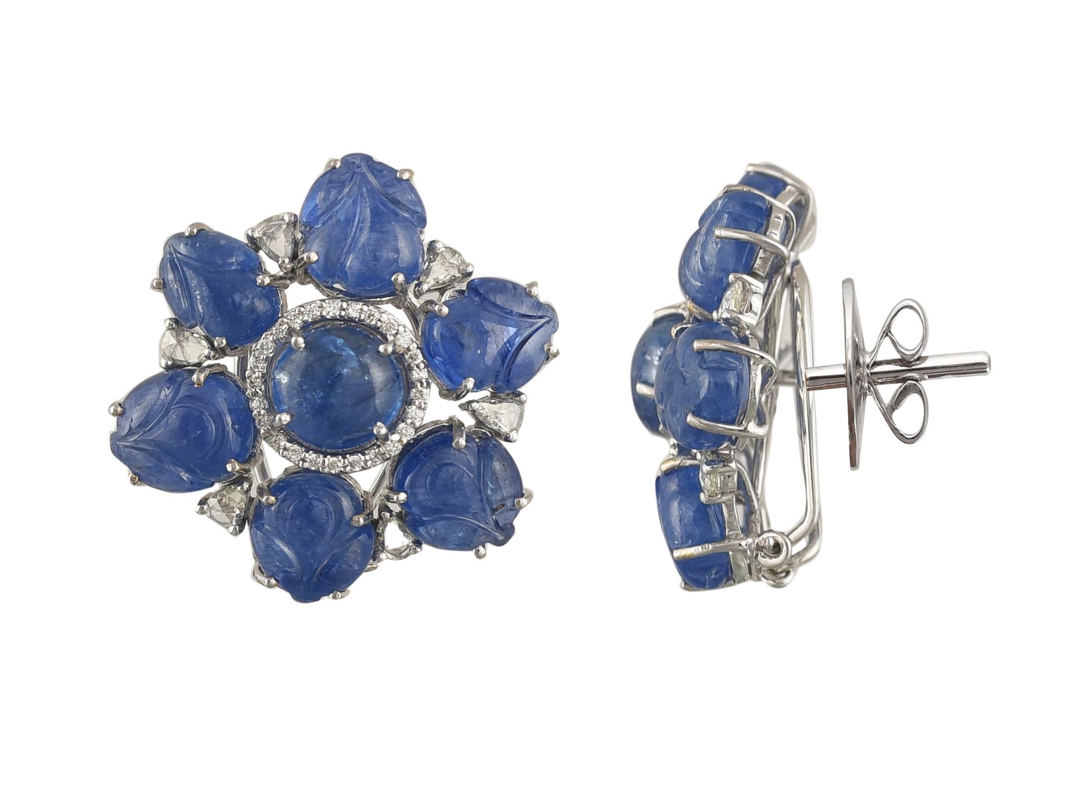 A very chic pair of Burmese Blue Sapphire stud earrings set in 18K white gold and diamonds. The Burmese sapphire is natural, no heat and weighs 37.12 carats. The Sapphires originate from Burma, and is in a combination of carving and cabochon. The