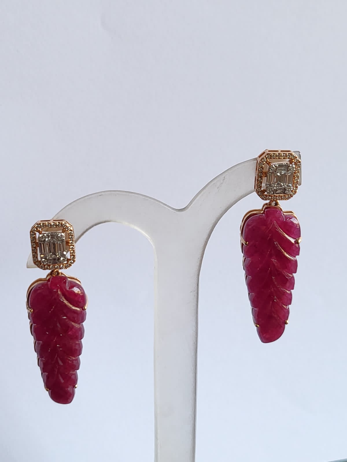 A very gorgeous and one of a kind, carved Ruby Chandelier Earrings set in 18K Rose Gold & Diamonds. The weight of the carved Ruby is 44.65 carats. The Ruby is completely natural, without any treatment and is of Mozambique origin. The Ruby is