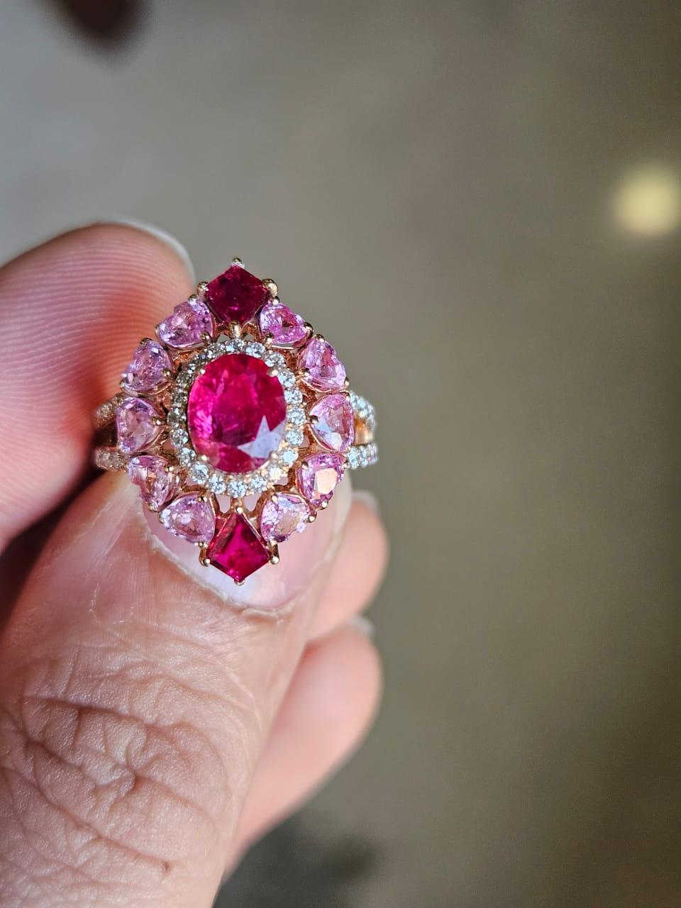 A very gorgeous and beautiful, Ruby & Pink Sapphires Cocktail Engagement Ring set in 18K Yellow Gold & natural Diamonds. The combined weight of the Rubies is 1.92 carats. The Rubies are completely natural, without any treatment and are of Mozambique