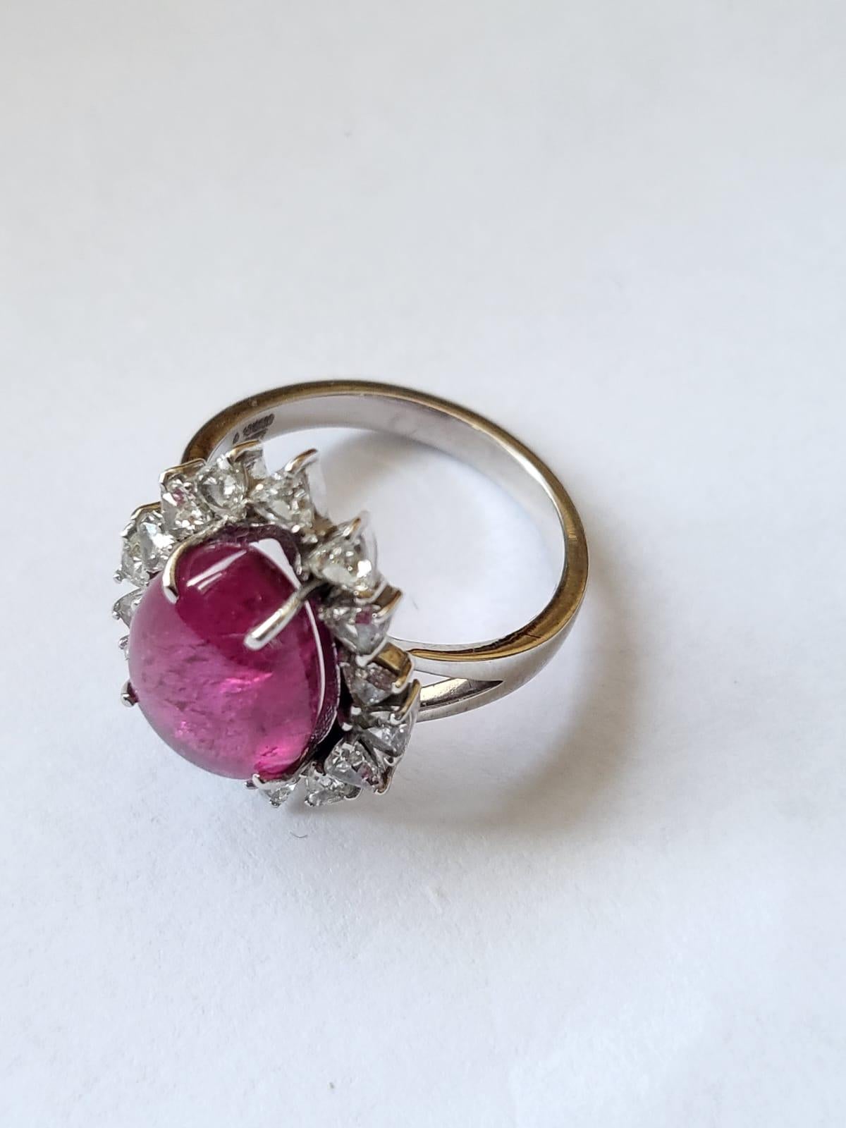 A very gorgeous and dainty Rubellite Engagement/ Cocktail Ring set in 18K Gold & Diamonds. The weight of the Tourmaline Cabochon is 5.65 carats. The weight of the Diamonds is 0.95 carats. Net Gold weight is 5.20 grams. The dimensions of the ring are