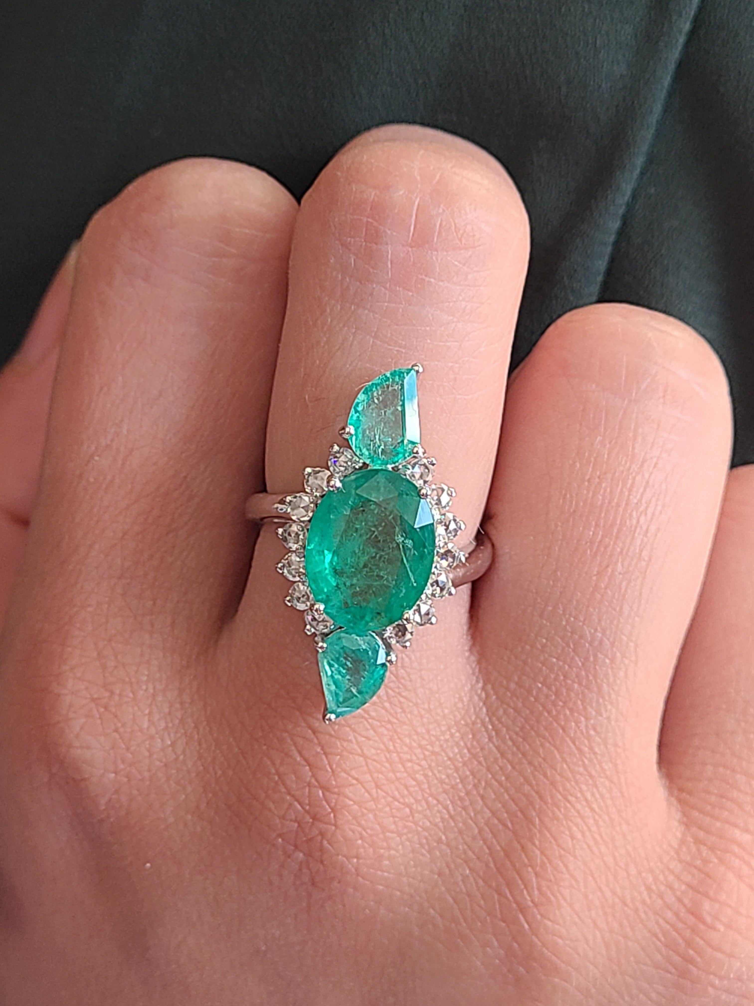 Magnifique et moderne, bague émeraude Cocktail / Three Stone sertie en or blanc 18k et diamants naturels. L'émeraude centrale pèse 4.24 carats. Le poids des pièces latérales d'émeraude est de 1,81 carat. Le poids du diamant est de 0,48 carat. Le