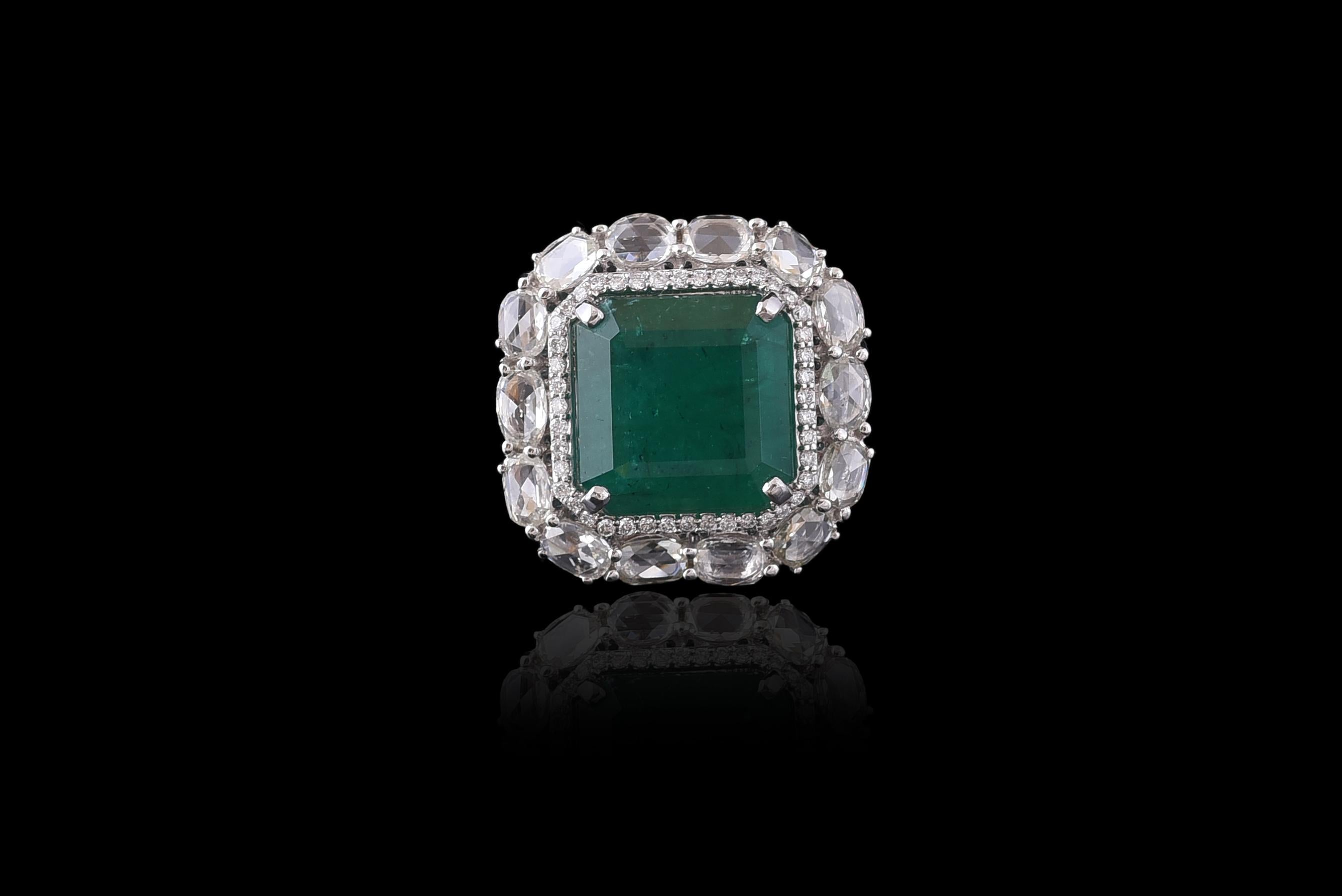 A classic Zambian Emerald and Rose Cut Diamond Cocktail Ring set in 18K white gold. The weight of the Emerald is 11.54 carats. The weight of the Rose cut diamonds is 3.08 carats. The Emerald is natural, and without any treatment and originates from