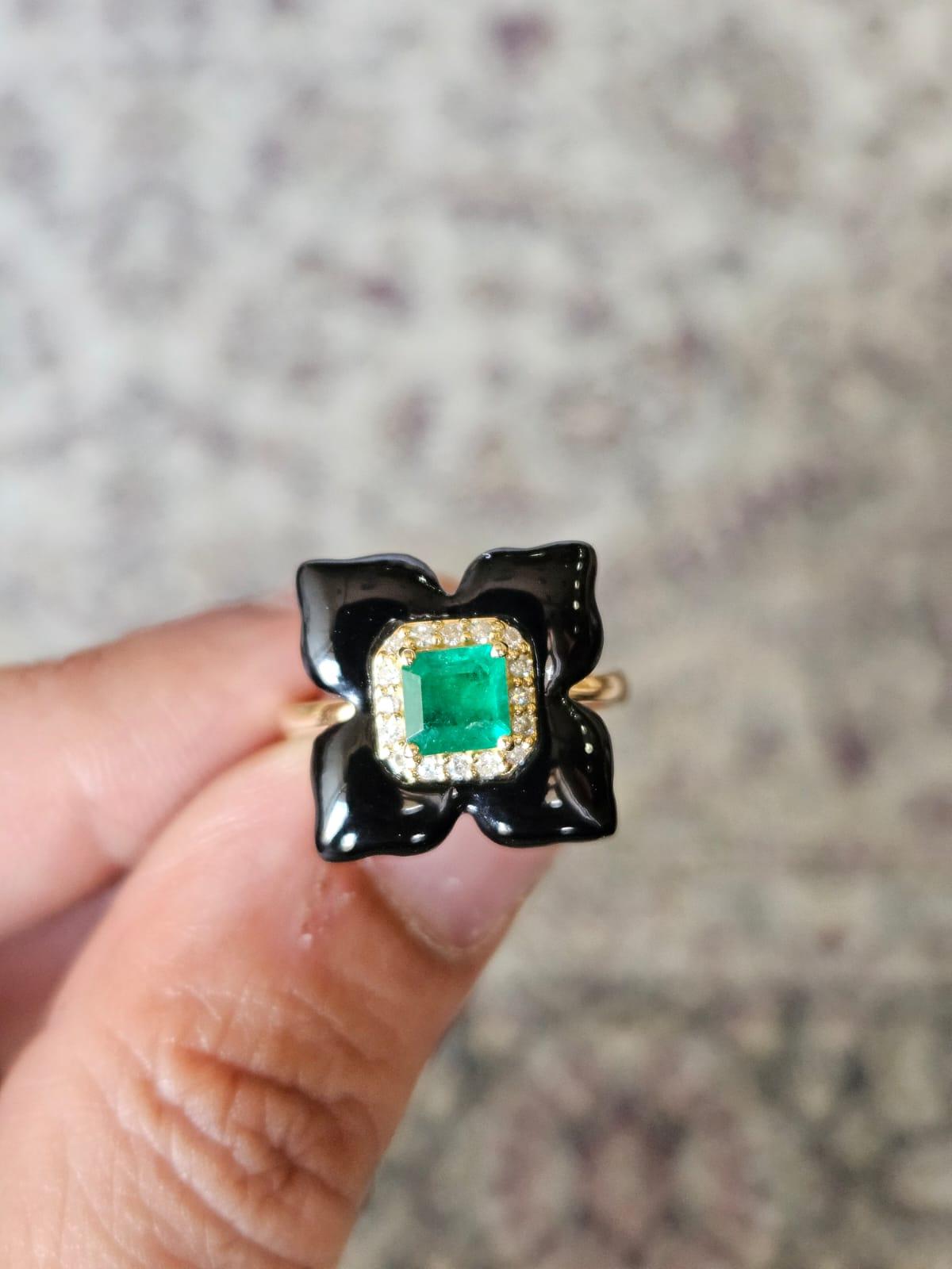 A very beautiful and chic, art - deco style, Black Onyx & Emerald Cocktail Ring set in 18K Yellow Gold & Diamonds. The weight of square Emerald is 0.53 carats. The Emerald is completely natural, without any treatment and is of Zambian origin. The