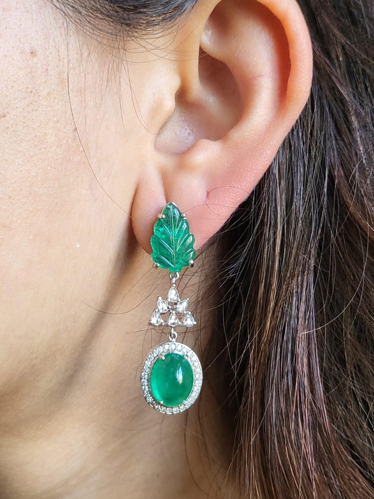 A very beautiful and gorgeous Emerald Earring set in 18K White Gold & Diamonds. The weight of the carved & cabochon Emerald is 5.85 carats and 7.69 carats, respectively. Both the Emeralds are completely natural, without any treatment is of Zambian