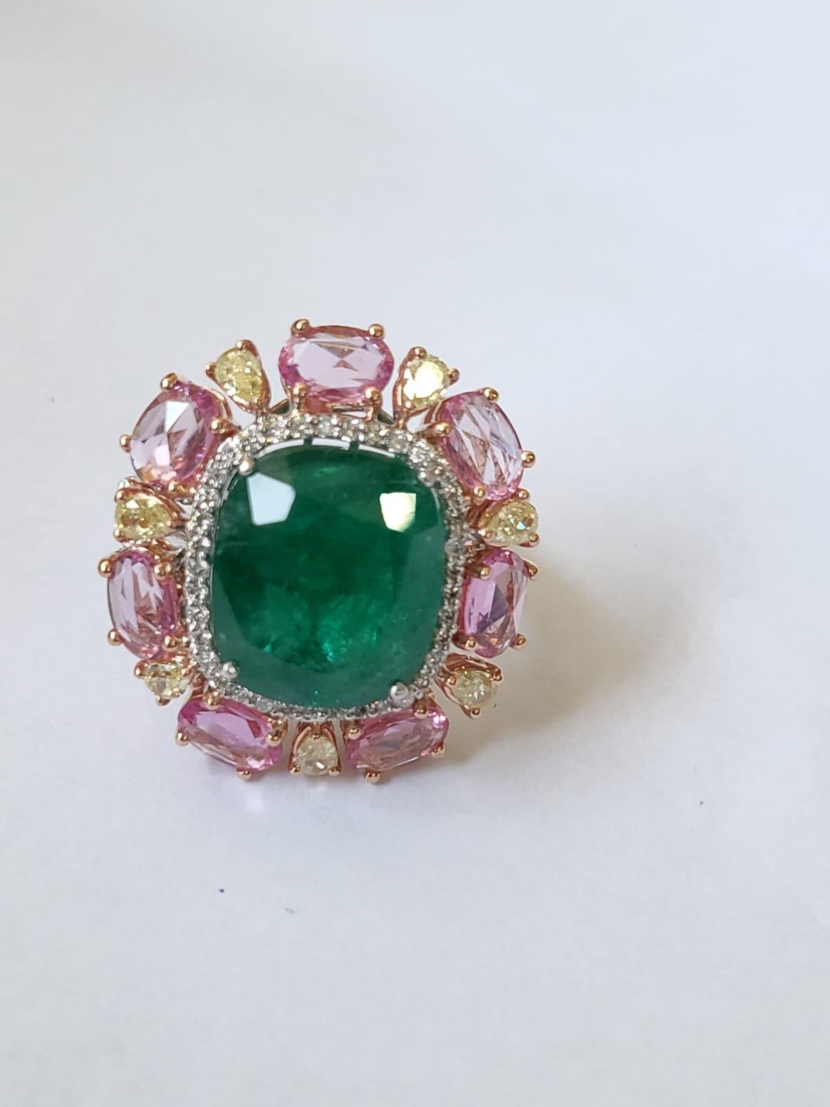 A very gorgeous Emerald & Pink Sapphire Cocktail Ring set in 18K White Gold & Diamonds. The weight of the Emerald is 9.36 carats. The Emerald is completely natural, without any treatment and is of Zambian origin. The weight of the Pink Sapphires is