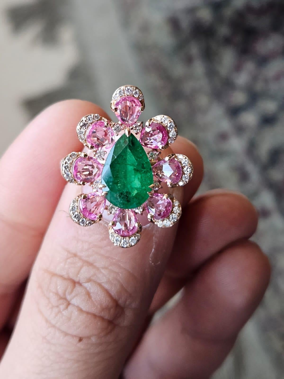 A very beautiful and gorgeous, Emerald & Pink Sapphire Cocktail Ring set in 18K Rose Gold. The weight of the pear shaped Emerald is 2.37 carats. The Emerald is completely natural, without any treatment and is of Zambian origin. The weight of the