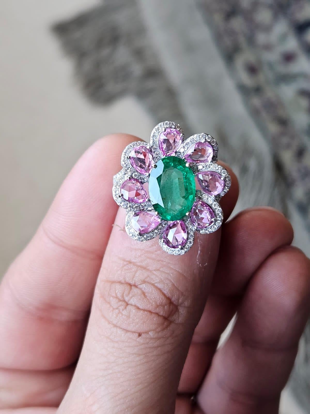 A very gorgeous and beautiful, Emerald & Pink Sapphire Cocktail Ring set in 18K Rose Gold & Diamonds. The weight of the oval shaped Emerald is 2.85 carats. The Emerald is completely natural, without any treatment and is of Zambian origin. The weight