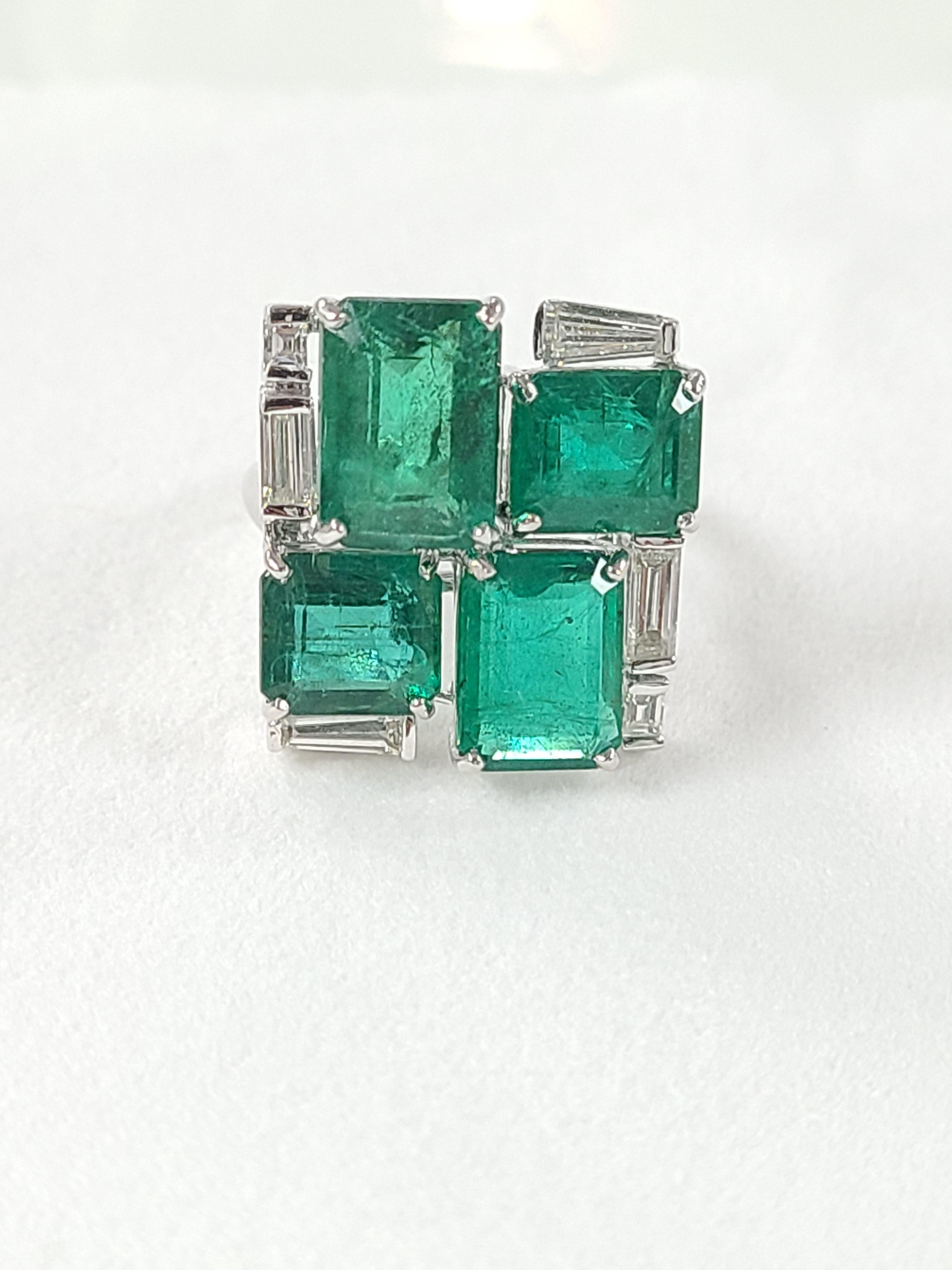 A wonderful modern chic ring set in white 18k gold with natural emerald with a combined weight of 10.5 carats ( 4 pieces) and diamond weight .87 carats. The ring size is US 6 and can be changed on request !