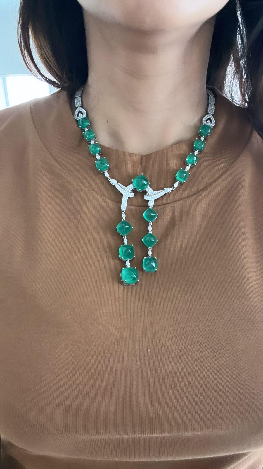 A very gorgeous and one of a kind, Emerald Drop Necklace set in 18K White Gold & Diamonds. The weight of the Emerald Sugarloafs is 74.16 carats. The Emeralds are completely natural, without any treatment and are of Zambian origin. The weight of the