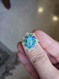 Set in 18K Gold, Paraiba, Blue Sapphires, Emerald & Diamond Engagement Ring