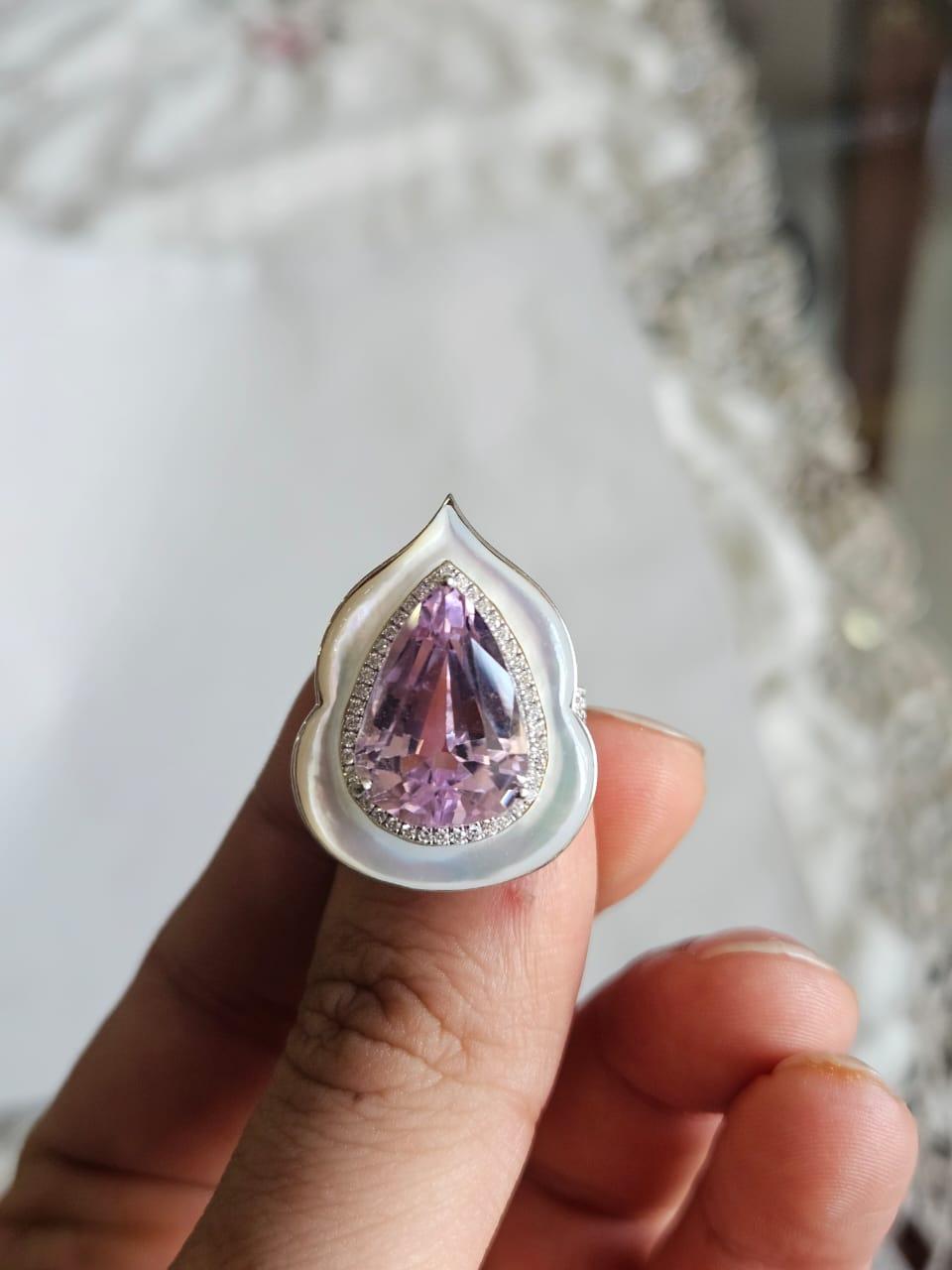 A very gorgeous and beautiful, modern style, Kunzite & Mother of Pearl Engagement Ring set in 18K White Gold & natural Diamonds. The weight of the Kunzite is 11.09 carats. The weight of the Mother of Pearl is 4.93 carats. The Diamonds weight is 0.43