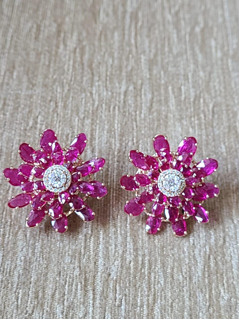A pair of gorgeous over-size Ruby and Diamonds Stud Earrings made in 18K Gold. The Ruby is of Mozambique origin and weighs 15.89 carats. The combined weight of the Diamonds is 0.62 carats. The gross weight of the Earrings is 14.74 grams. The
