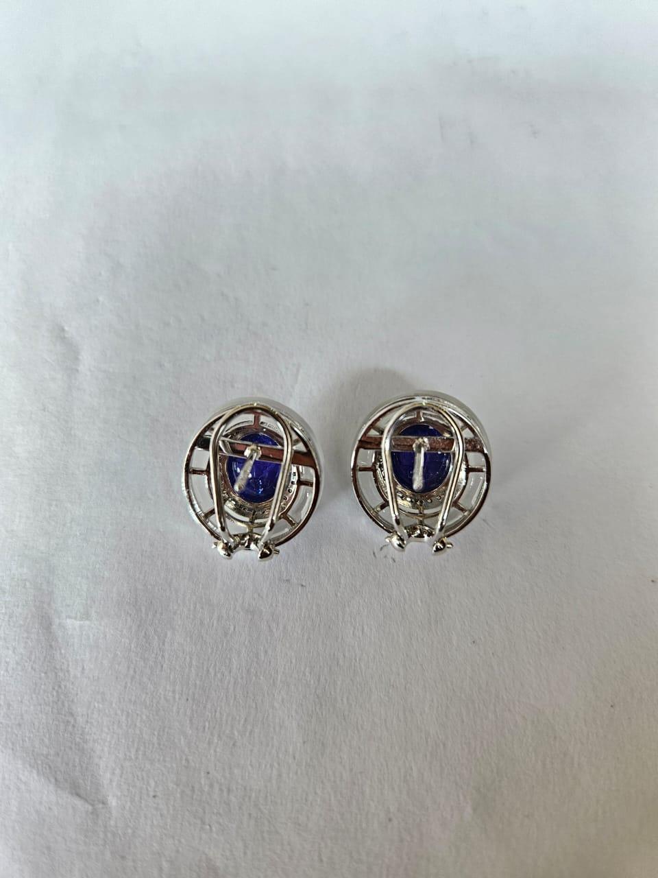 A very gorgeous and unique, Tanzanite & Rock Crystal Stud Earrings set in 18K White Gold & natural Diamonds. The weight of the Tanzanite cabochons is 11.19 carats. The Tanzanites are responsible sourced from Tanzania. The weight of the Rock crystal