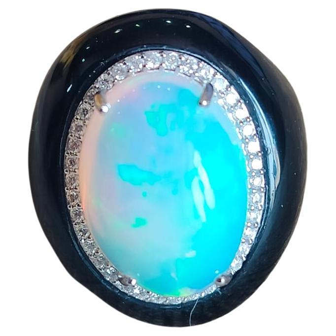 A very gorgeous and beautiful, Modern style Opal & Black Onyx Ring set in 18K Gold & Diamonds. The weight of the Opal is 8.04 carats. The Opal is of Ethiopian origin. The Opal has a gorgeous Orange & Blue play of colour. The weight of Black Onyx is