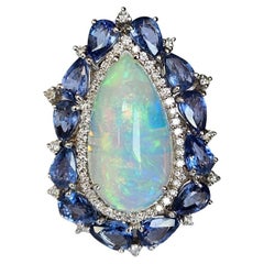 Set in 18K Gold, white Ethiopian Opal, Blue Sapphires 
Diamonds Cocktail Ring