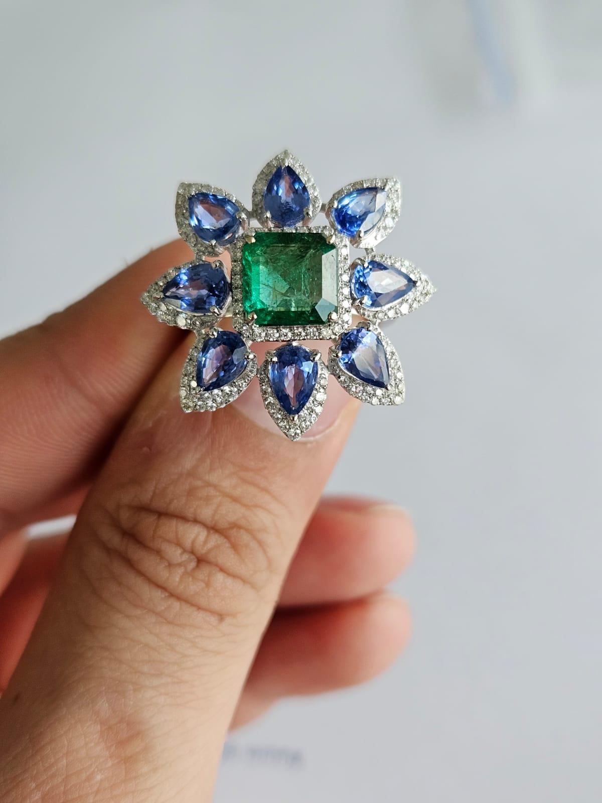 A very gorgeous and beautiful, modern style Emerald & Blue Sapphire Cocktail Ring set in 18K White Gold & Diamonds. The weight of the Emerald is 2.08 carats. The square shaped Emerald is completely natural, without any treatment and is of Zambian