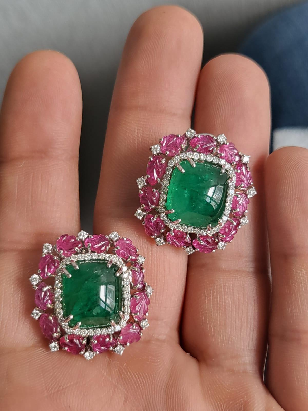 Ein wunderschöner und einzigartiger Smaragd- und Rubin-Ohrstecker in 18 Karat Weißgold. Das Gewicht der Smaragd-Cabochons beträgt 15,96 Karat. Die Smaragde sind völlig natürlich, ohne jegliche Behandlung und sind sambischen Ursprungs. Das Gewicht