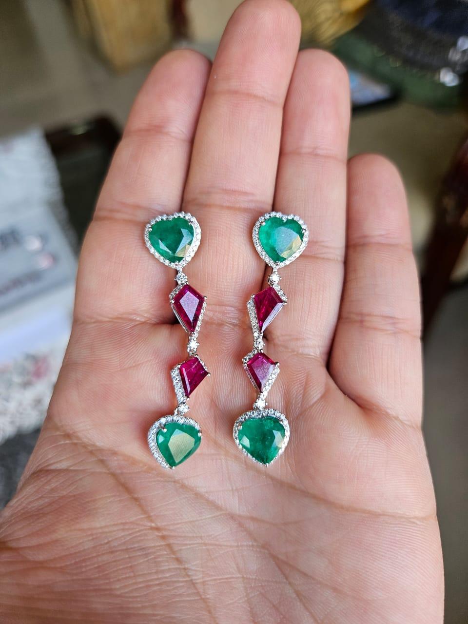 A very gorgeous and beautiful, modern style Emerald & Ruby Chandelier Earrings set in 18K White Gold. The weight of the heart shaped Emeralds is 8.37 carats. The Emeralds are completely natural, without any treatment and are of Zambian origin. The