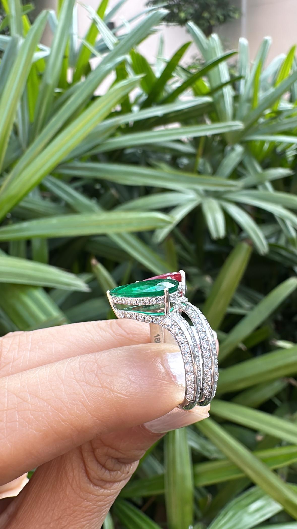 A very gorgeous and beautiful, modern style, Emerald & Ruby Engagement Ring set in 18K White Gold & natural Diamonds. The weight of the pear shaped Emerald is 2.05 carats. The Emerald is completely natural, without any treatment and is of Zambian