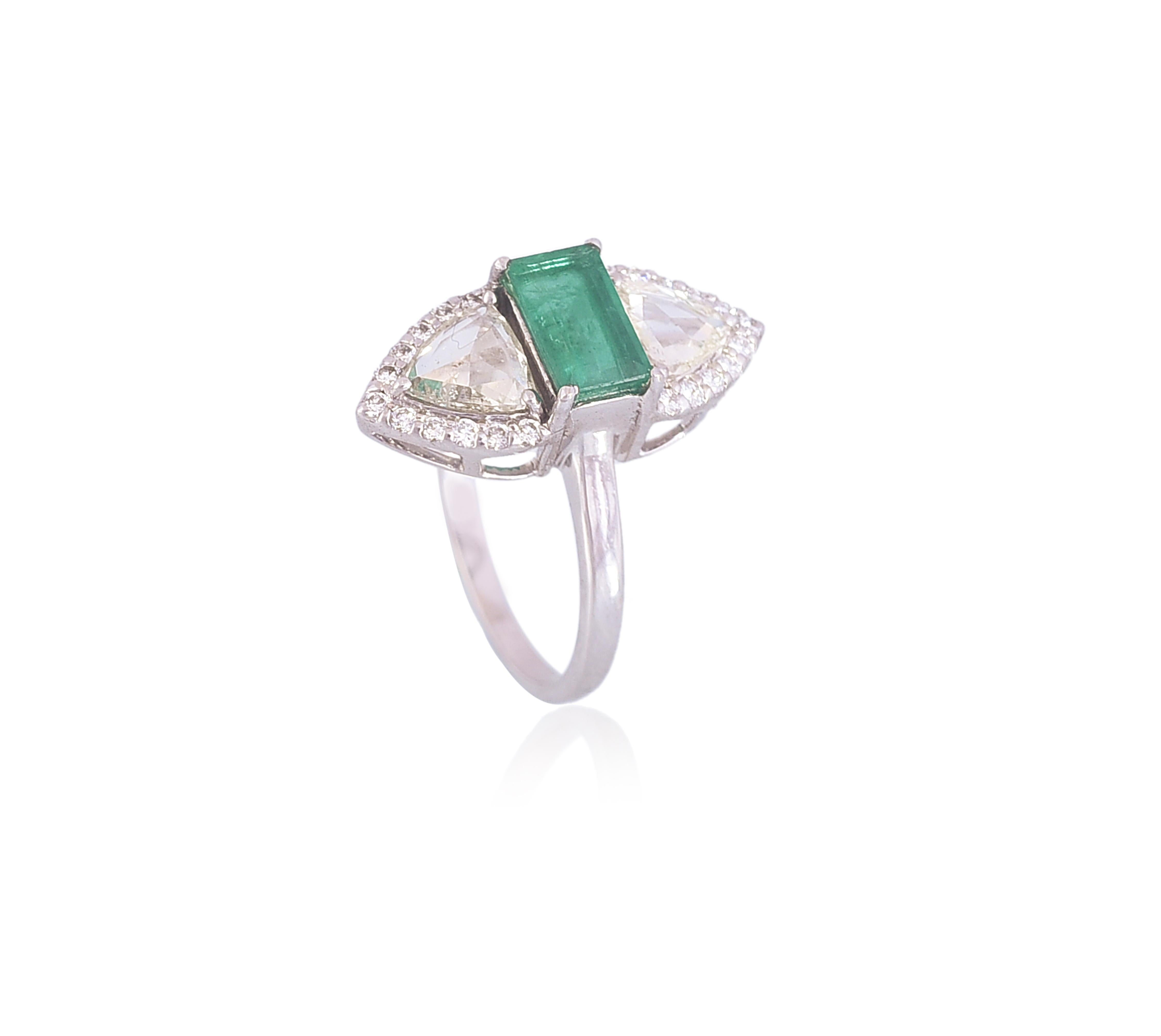 A very artistic piece of Emerald & Diamonds Cocktail Ring set in 18K White Gold. The weight of the Emerald is 0.97 carats. The Emerald is completely natural without any treatment and originates from Zambia. The combined weight of the Diamonds is