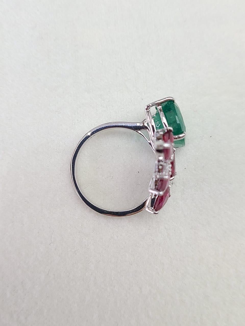 A very gorgeous Zambian Emerald & Ruby Cocktail Ring set in 18K Gold & Diamonds. The Emerald is of Zambian origin and is completely natural without any treatment. The marquise shaped Ruby is from Mozambique and is also completely natural without any