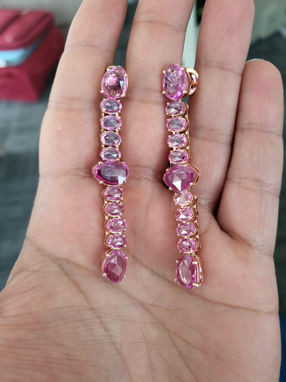 A very gorgeous and beautiful, Pink Sapphire Chandelier Earrings set in 18K Rose Gold. The weight of the Pink Sapphire Rose Cuts is 15.14 carats. The Pink Sapphires are of Ceylon (Sri Lanka) origin. Net Gold weight is 15.01 grams. The dimensions of