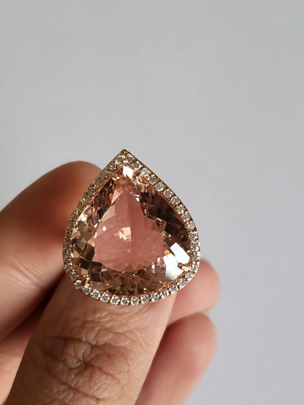 A very gorgeous and beautiful, Morganite Engagement / Cocktail Ring set in 18K Rose Gold & Diamonds. The weight of the Morganite is 16.21 carats. The weight of the Diamonds is 0.50 carats. Net Gold weight is 8.41 carats. The dimensions of the ring