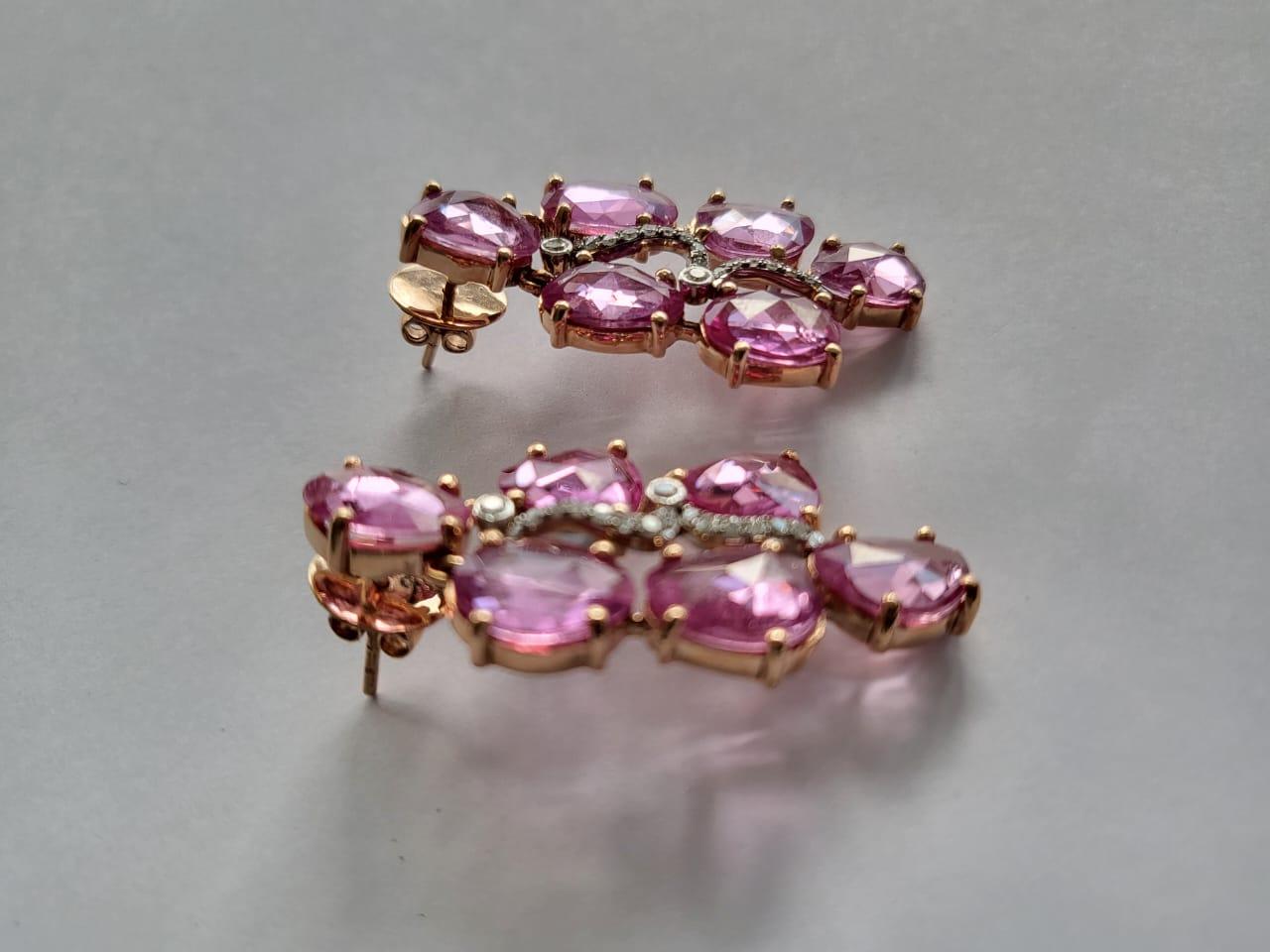 A very gorgeous and modern, Pink Sapphire Stud Earrings set in 18K Rose Gold & Diamonds. The weight of the Pink Sapphires Rose Cuts is 18.25 carats. The Pink Sapphires are of Ceylon (Sri Lanka) origin. The weight of the Diamonds is 0.34 carats. Net
