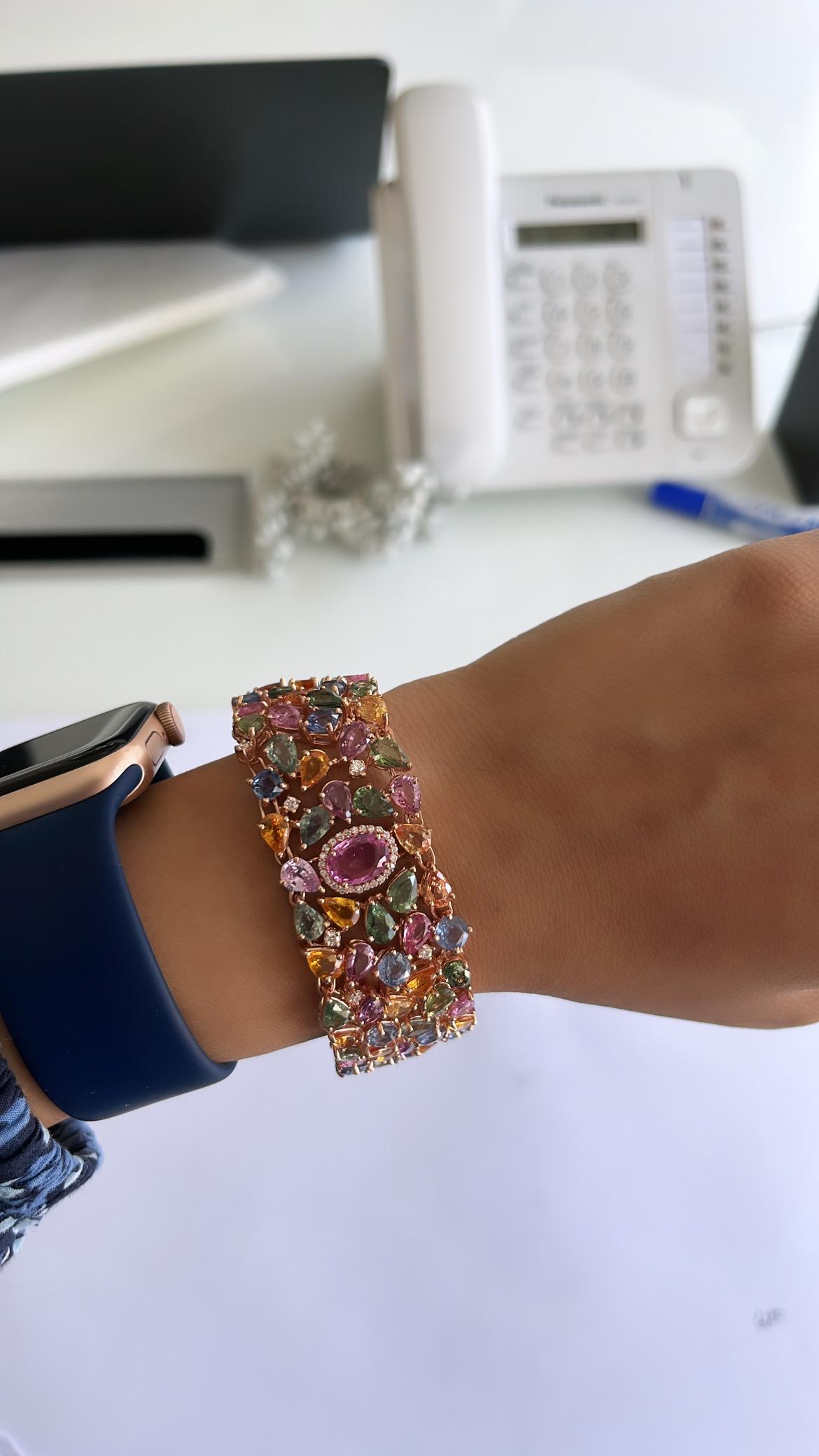 A very gorgeous and one of a kind, Multi Sapphire Link Bracelet set in 18K Rose gold & Diamonds. The weight of the Multi Sapphires is 62.26 carats. The weight of the centre Pink Sapphire is 1.45 carats. All the Sapphires are natural and are of