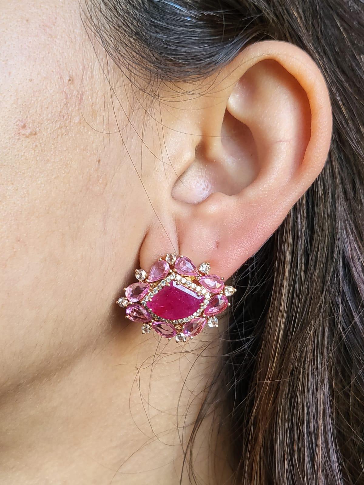 A very gorgeous Ruby & Pink Sapphire Stud Earrings set in 18K Rose Gold & Diamonds. The weight of the Rubies is 6.17 carats. The Rubies are completely natural, without any treatment and is of Mozambique origin. The weight of the Pink Sapphires is