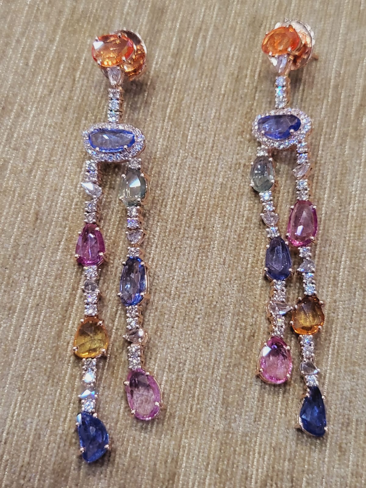 A very chic and gorgeous Multi Sapphires Chandelier/ Dangle Earrings set in 18K Rose Gold & Diamonds. The weight of the Multi Sapphires is 12.37 carats. The Multi Sapphires are of Ceylon (Sri Lanka) origin. The combined Diamonds weight is 2.33