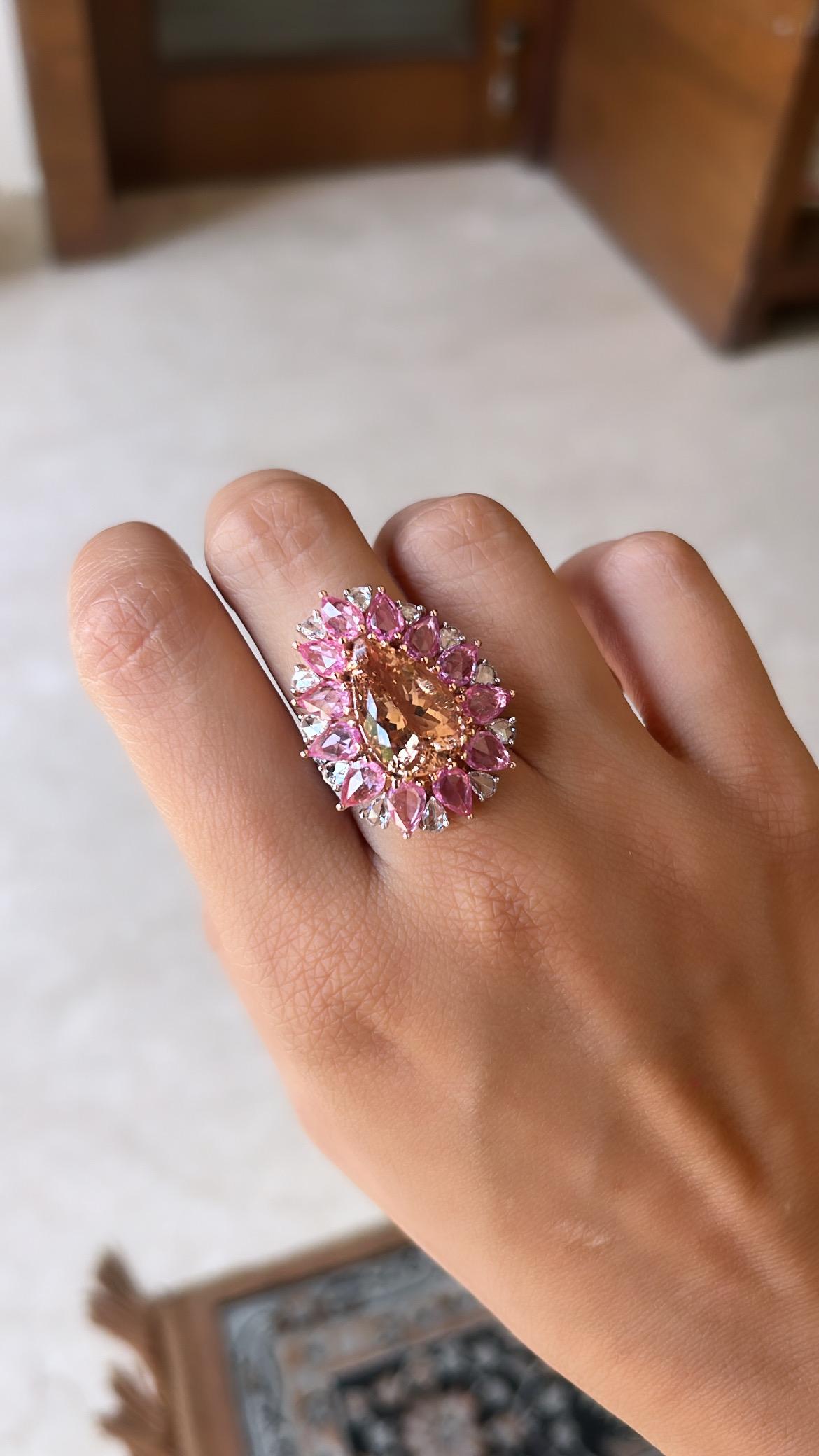 A very gorgeous and one of a kind, Morganite & Pink Sapphires Cocktail Ring set in 18K Rose Gold. The weight of the Morganite is 7.05 carats. The Morganite is natural, without any treatment. The weight of the Pink Sapphires is 3.76 carats. The Pink