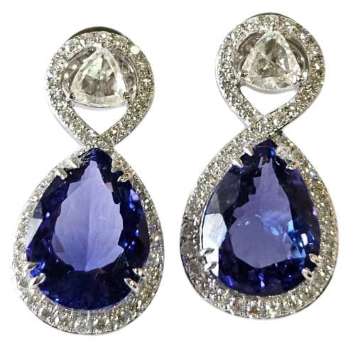 A very gorgeous and beautiful, modern style, Tanzanite Drop Earrings set in 18K White Gold & natural Diamonds. The weight of the pear shaped Tanzanite is 14.52 carats. The Tanzanites are responsibly sourced from Tanzania. The combined Diamonds
