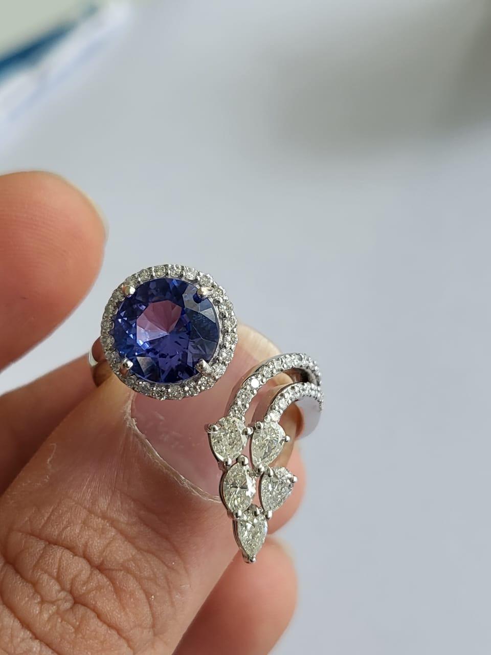 A very beautiful and modern, Tanzanite Engagement Cocktail Ring set in 18K White Gold & Diamonds. The weight of the Tanzanite is 2.63 carats. The Tanzanite is responsibly sourced from Tanzania. The combined weight of the Diamonds is 0.92 carats. Net