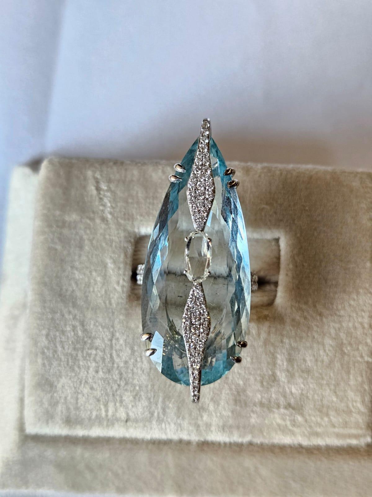 A very gorgeous and beautiful, Aquamarine Cocktail Ring set in 18K White Gold & natural Diamonds. The weight of the Pear shaped Aquamarine is 30.03 carats. The combined Diamonds weight is 1.66 carats. Net 18K White Gold weight is 7.26 grams. The