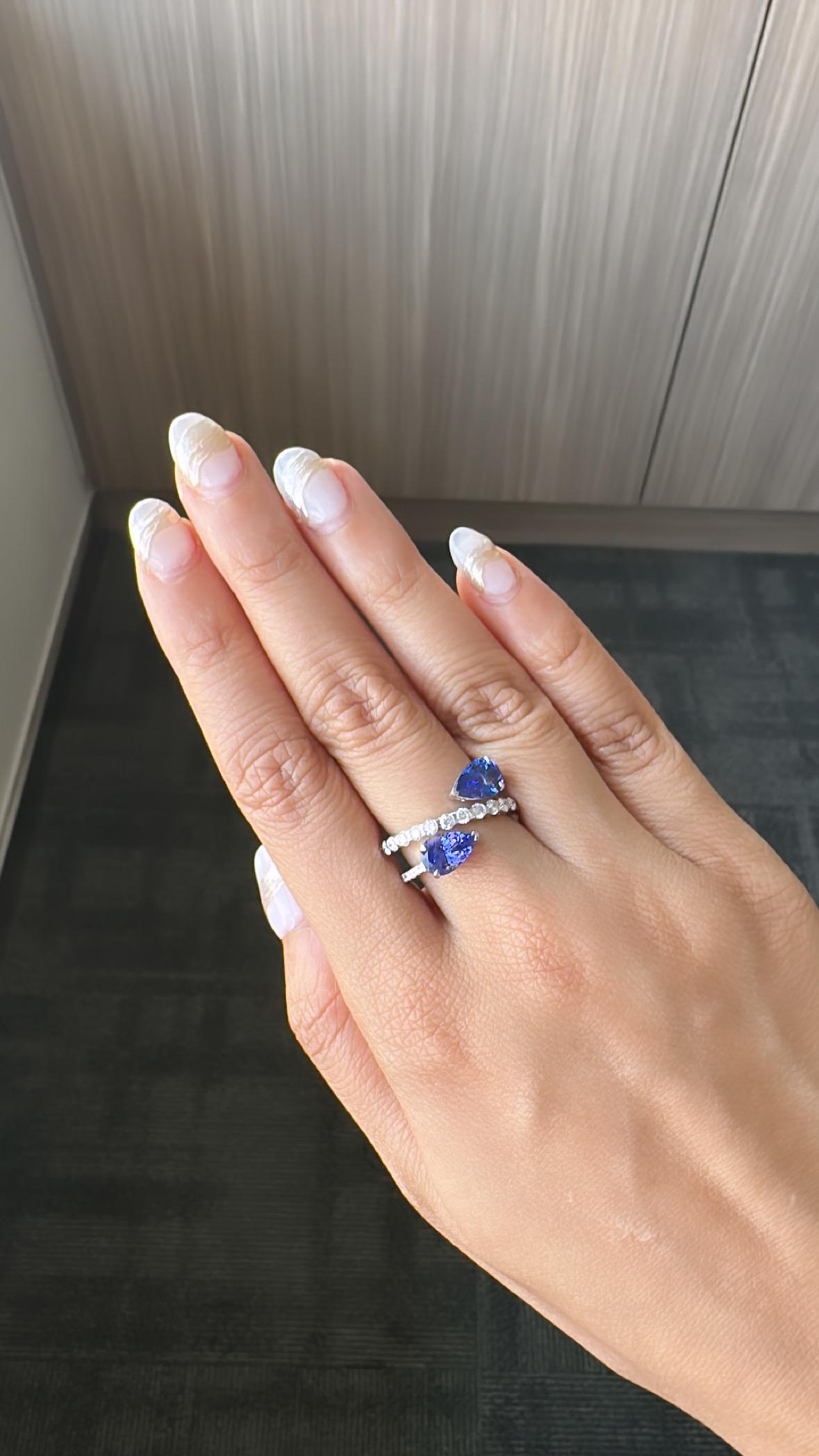 A very gorgeous and beautiful, Tanzanite Band / Wedding Ring set in 18K White Gold & Diamonds. The weight of the pear shaped Tanzanites is 3.11 carats. The Tanzanites are natural and responsibly sourced from Tanzania. The Diamonds weight is 0.89