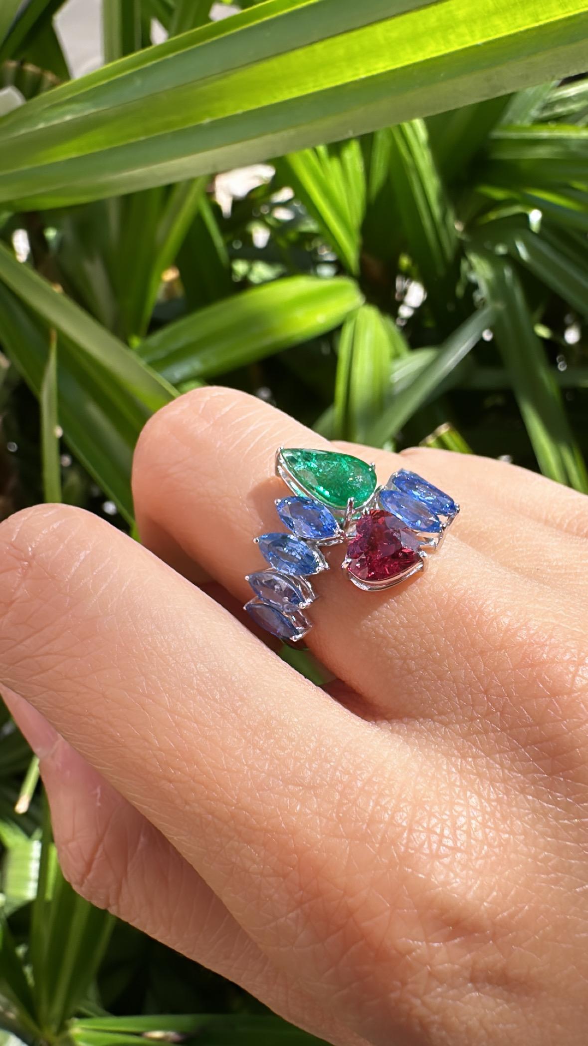 A very beautiful and gorgeous, Blue Sapphire, Emerald & Rubellite Band Ring set in 18K White Gold. The weight of the Marquise shaped Blue Sapphires is 3.44 carats. The Blue Sapphires are of Ceylon (Sri Lankan) origin. The weight of the pear shaped