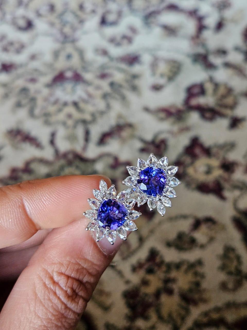 A very gorgeous and modern, Tanzanite Cocktail Ring set in 18K White Gold & Diamonds. The weight of the Tanzanites is 3.86 carats. The Tanzanites are responsibly sourced from Tanzania. The Rose Cut Diamonds weight is 1.52 carats. Other Diamonds