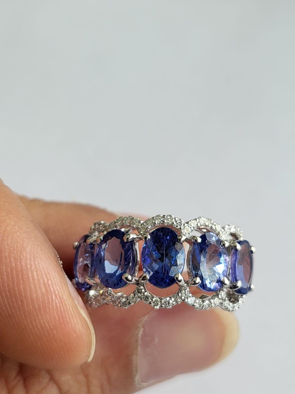 A very gorgeous and beautiful, Tanzanite Band / Wedding Ring set in 18K Gold & Diamonds. The weight of the Tanzanite ovals is 4.17 carats. The Tanzanites are responsibly sourced from Tanzania. The weight of the Diamonds is 0.47 carats. Net Gold